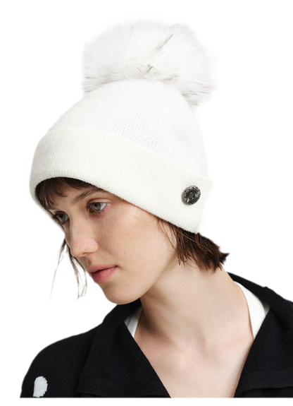 Cappello in lana con pompon e visiera